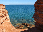 View of the water through rocks at Gantheaume Point, Broome
